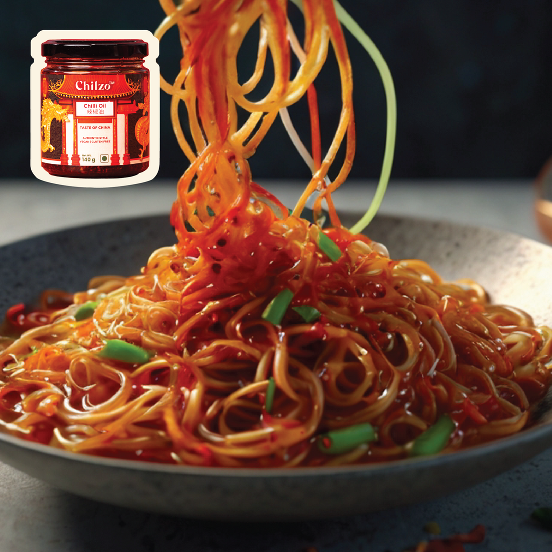 Chilli oil noodles recipe featuring spicy red hues with fresh green garnishes. 