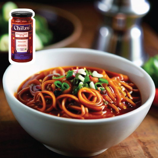 A bowl of spicy noodles made with Chilzo's Schezwan sauce, topped with hot and crunchy chilli oil. 