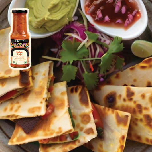 A mouthwatering Chilzo's Salsa Roja Quesadilla, with a crispy tortilla wrapped around a gooey, cheesy filling, garnished with fresh cilantro and served with a side of sour cream and salsa