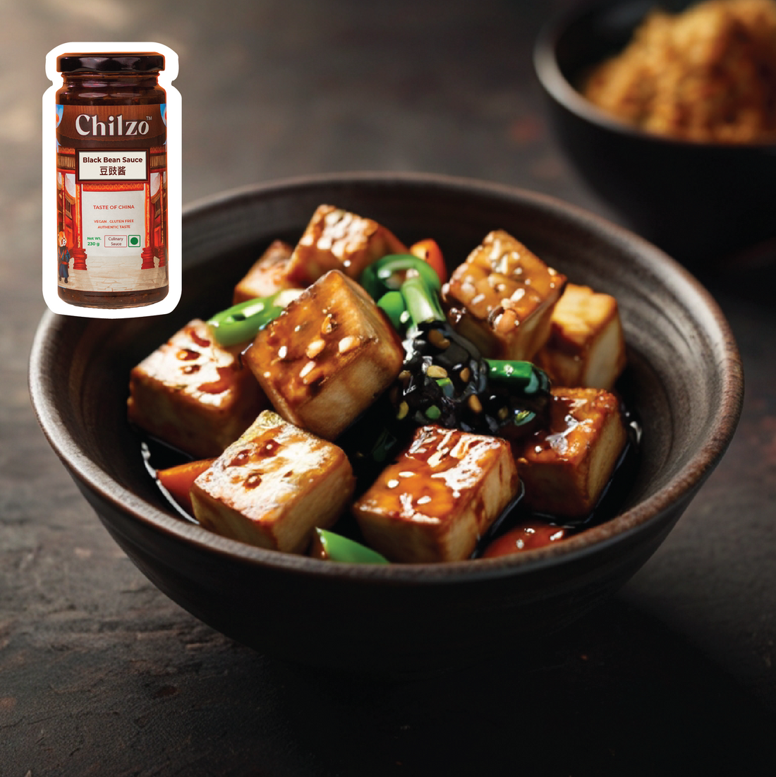 Stir-fried Tofu recipe with Chilzo's black bean sauce and oyster sauce topped with fresh scallions